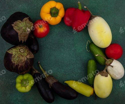 Preview: top view copy space white and black eggplants with bell peppers tomatoes and cucumbers on a green
