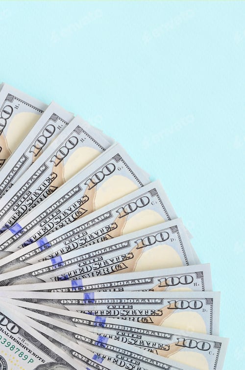 Preview: Fan of a US dollar bills of a new design lies on a light blue background