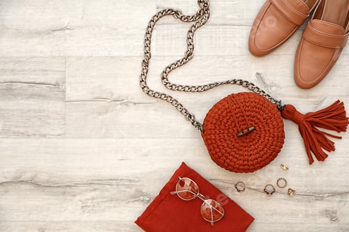 Preview: Stylish set with knitted bag and space for design on wooden background, flat lay