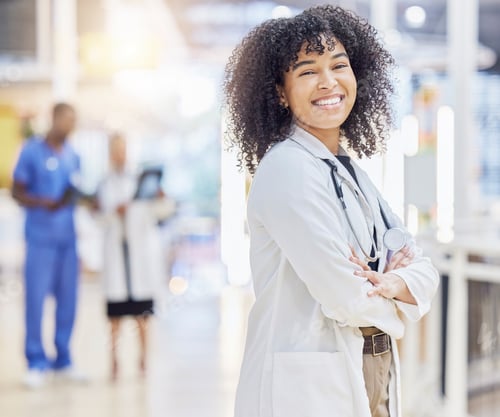 Preview: Portrait, happy doctor and woman with arms crossed in hospital for healthcare. Face, confidence and