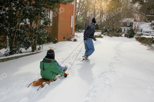 Preview: Family time with Dad pulling his son in the sled, enjoying the snow around the neighborhood.