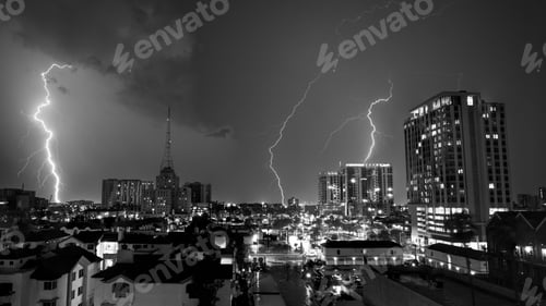 Preview: Grayscale of striking lightning at night in an illuminated city of Phoenix, Arizona
