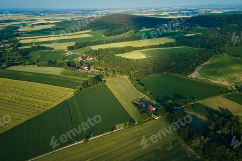 Preview: Aerial view of countryside area with village and mountains