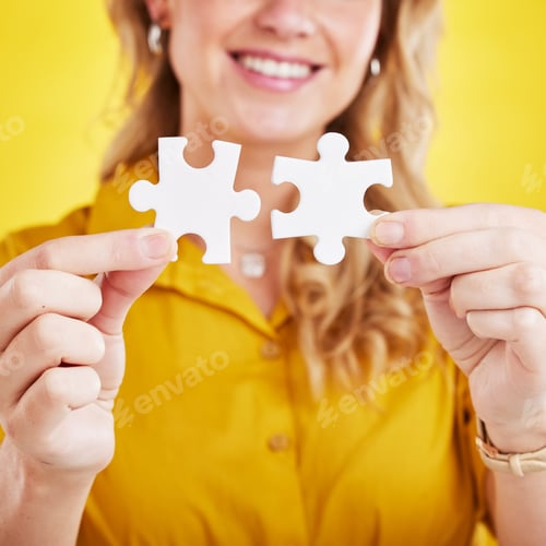 Preview: Hands, puzzle and woman in studio for problem solving, solution and innovation against yellow backg