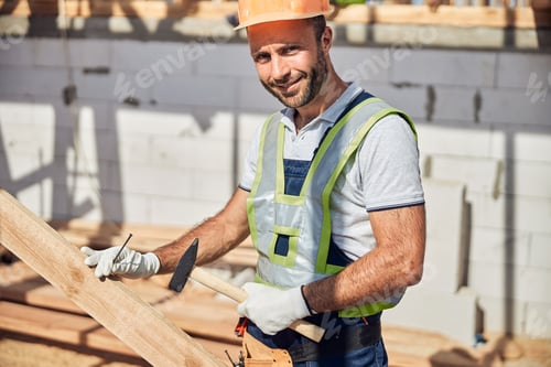 Preview: Portrait of delighted worker holding hammer in his hand