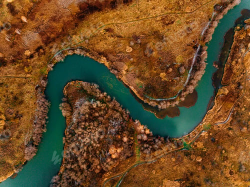 Preview: Aerial view of turquoise winding river and golden autumn