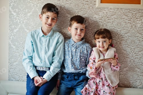 Preview: Three kids. Girl with mobile phone at hand.