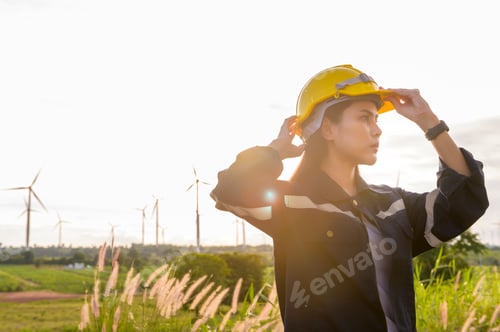 Preview: Woman engineer is putting a protective helmet on her head