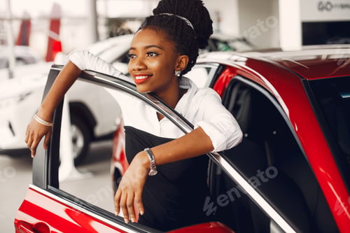 Preview: Stylish black woman in a car salon