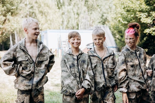 Preview: Group of teenager boy and girl in military uniform standing and waiting laser tag shooting game