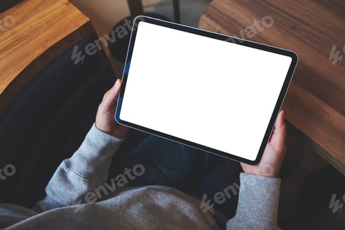 Preview: Top view mockup image of a woman holding digital tablet with blank white desktop screen in cafe
