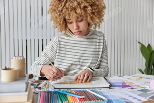 Preview: Serious curly haired young woman plans apartment renovation involved in creating interior design