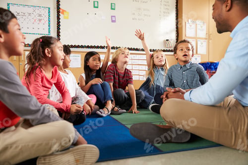 Preview: Elementary school kids and teacher sit cross legged on floor