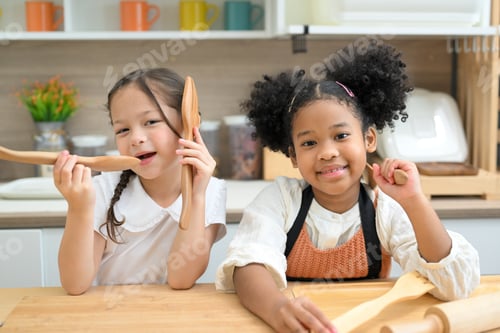 Preview: Two Cheerful Girls Baking in Kitchen