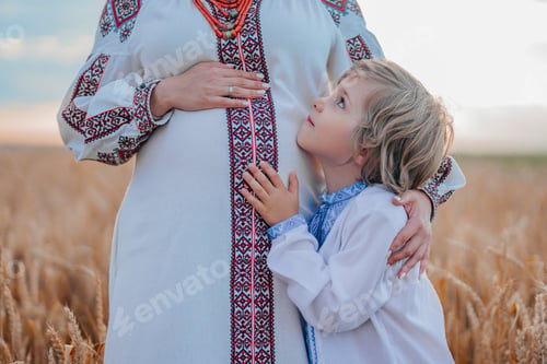 Preview: Pregnant Ukrainian Mom Son In Wheat Field. Happy Smiling Boy Brother Touching mothers bump tummy.