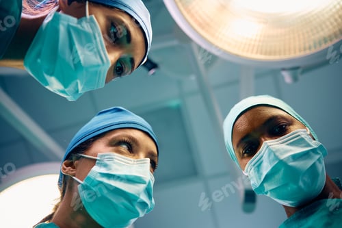 Preview: Below view of female surgeons in operating room.