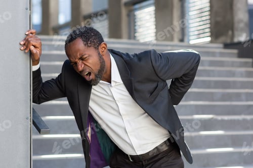 Preview: African american man overworked outside office building, boss in business suit has severe back pain