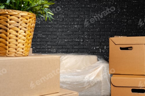 Preview: Moving in or moving out concept. Stack of boxes and packed furniture