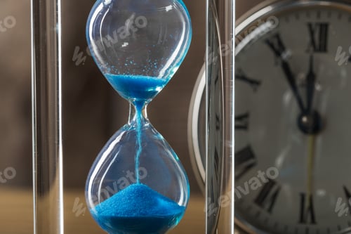 Preview: Time is passing. Blue hourglass close up