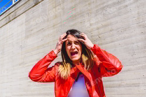 Preview: Frightened young woman gesturing with fear after a robbery.