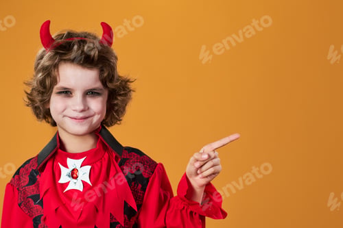 Preview: Youthful smiling boy with red horns