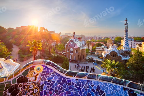 Preview: Barcelona city view from Guell Park. Sunrise view of colorful mosaic building in Park Guell
