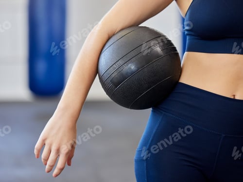 Preview: Fitness, exercise and woman with medicine ball in a health and wellness gym for training or weight
