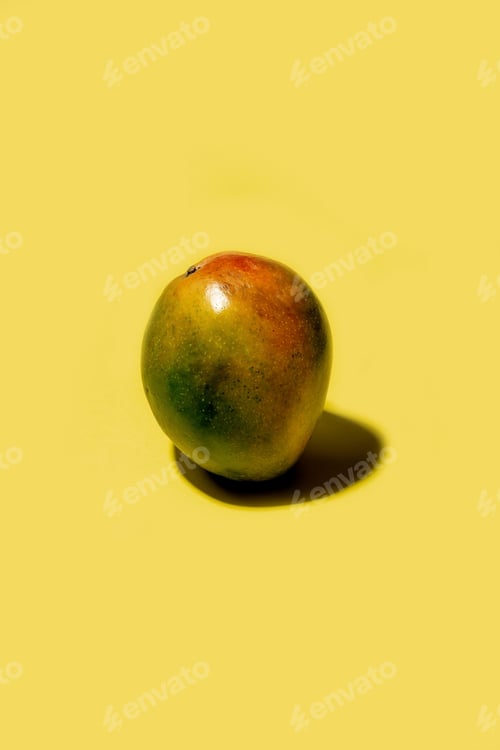 Preview: Ripe mango on a solid yellow background