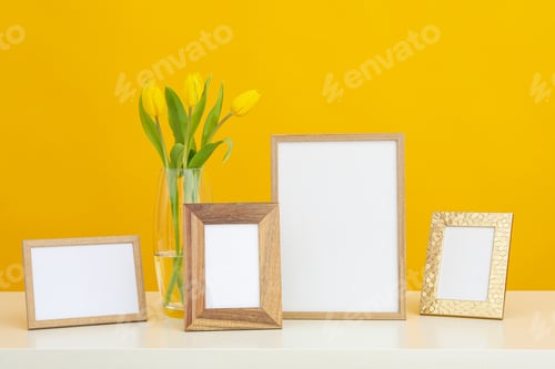 Preview: Photo frames with blanks on the table on a yellow background
