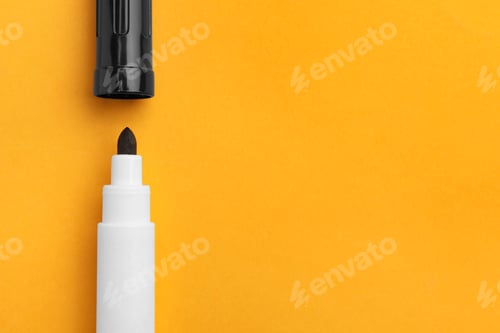 Preview: Black marker on orange background, flat lay. Space for text