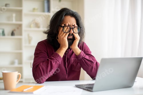 Preview: Glaucoma Concept. Tired Young Indian Man Massaging Eyes After Working On Laptop