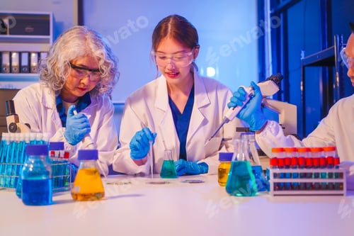 Preview: Two Asian men and women sit at a table in a laboratory, conducting research on liquids. They use
