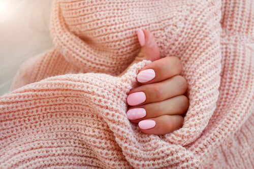 Preview: Female hands with beautiful oval-shaped nails, matte pink manicure