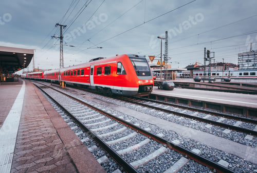 Preview: Railway station with modern red passenger train. Industrial land