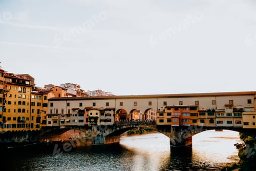 Preview: FLORENCE, ITALY - JULY 17, 2017: Famous Ponte Vecchio bridge with river Arno at sunset in Florence,