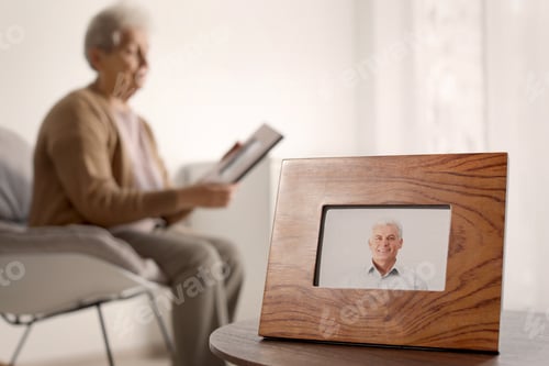 Preview: Framed photo of man and blurred female pensioner on background. Space for text