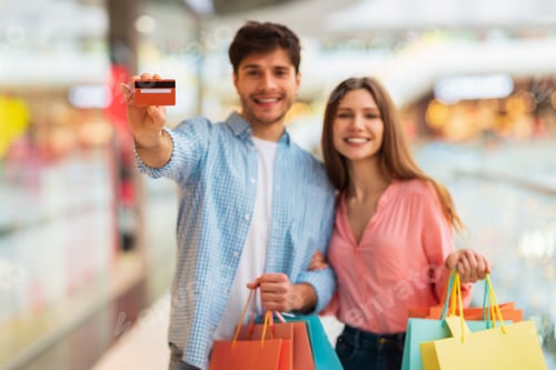 Preview: Happy Couple Shopping And Showing Credit Card In Mall Indoors