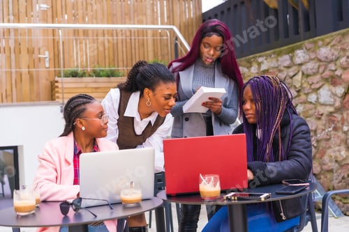 Preview: Young businesswomen of black ethnicity. In a business meeting in a cafeteria