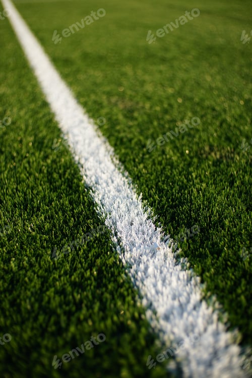 Preview: green synthetic grass surface on a soccer ground, european football field with artificial grass