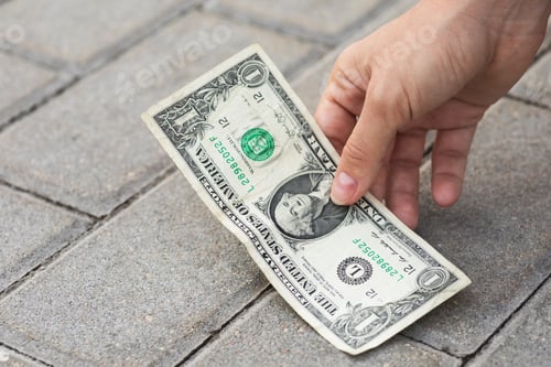 Preview: Woman is picking one dollar banknote from the ground.