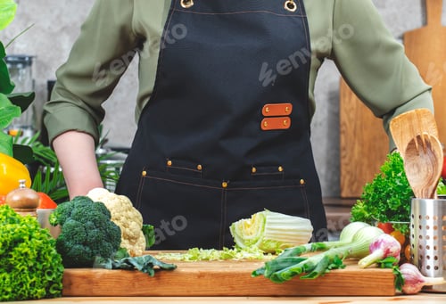 Preview: Chef cooking food in the kitchen. Cook and Chinese cabbage on wooden table