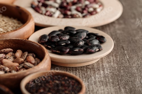 Preview: brown bowls and plates with black beans and grains on table