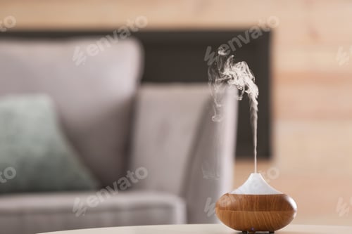 Preview: Aroma oil diffuser lamp on table against blurred background