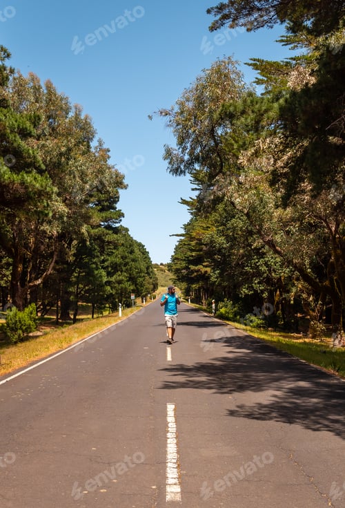 Preview: Mountaineer walking on the road in the trekking of La Llania in El Hierro, Canary Islands