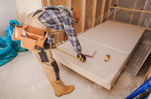 Preview: General Construction Worker in His 40s Measuring Drywall Boards