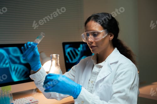 Preview: Female scientist analyzing liquid in test tube for genetic research