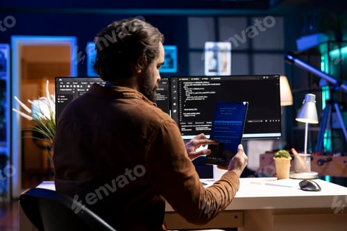 Preview: Programmer using tablet to fix vulnerabilities compromising systems