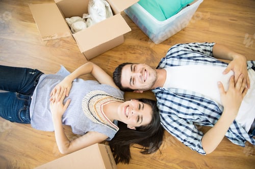 Preview: Happy Couple Lying By Boxes On Floor In New Home