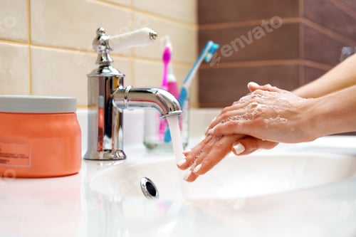 Preview: Woman washing her hands with soap close up