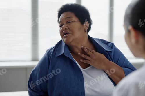 Preview: Senior Black Woman Describing Skin Condition during Dermatology Consultation
